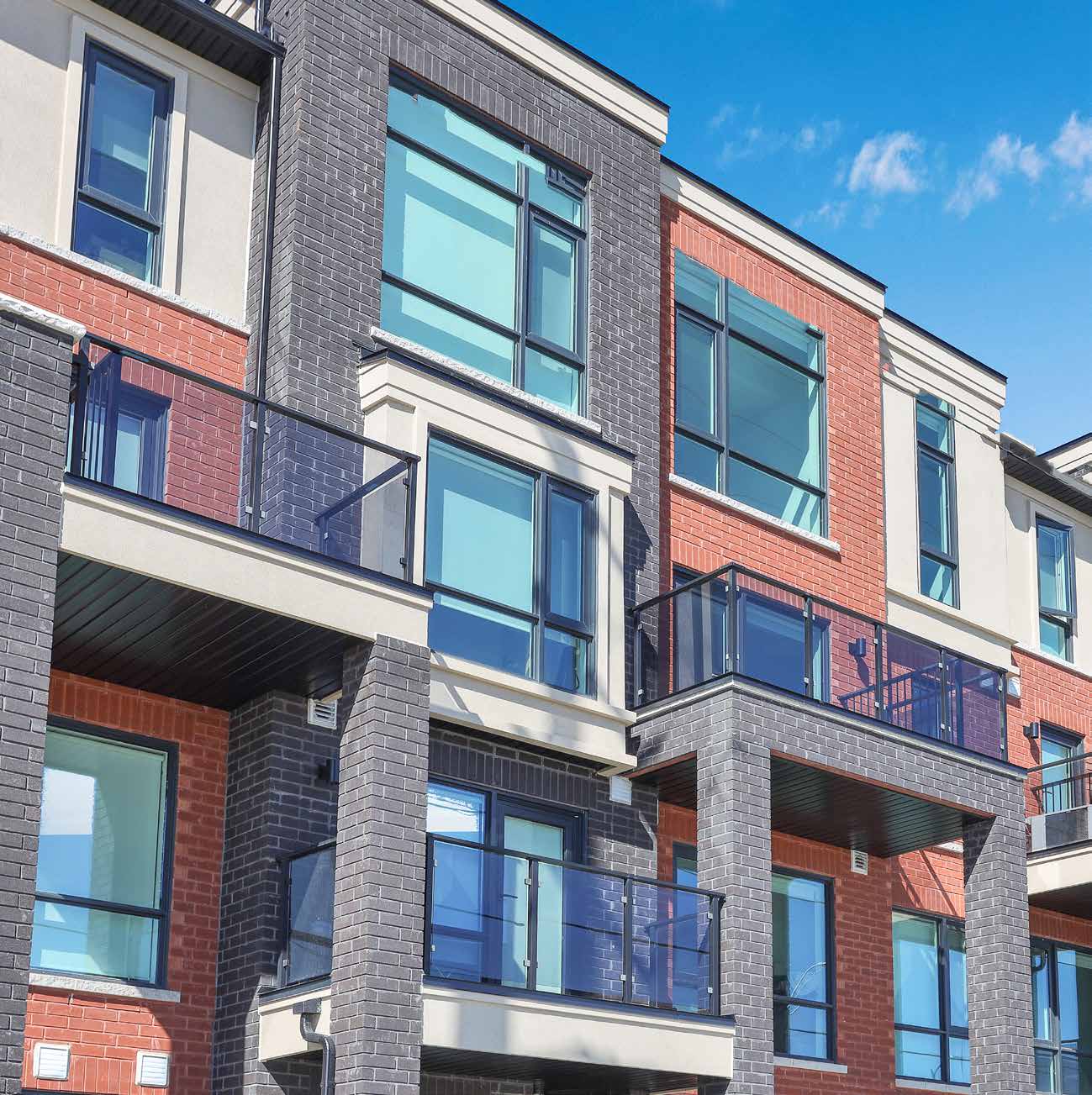 Countryside Urban Towns exterior with brick, stucco and glass balconies