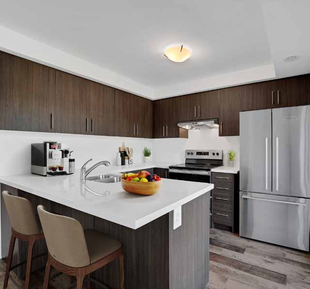 Kitchen with dark wood cabinetry and breakfast bar
