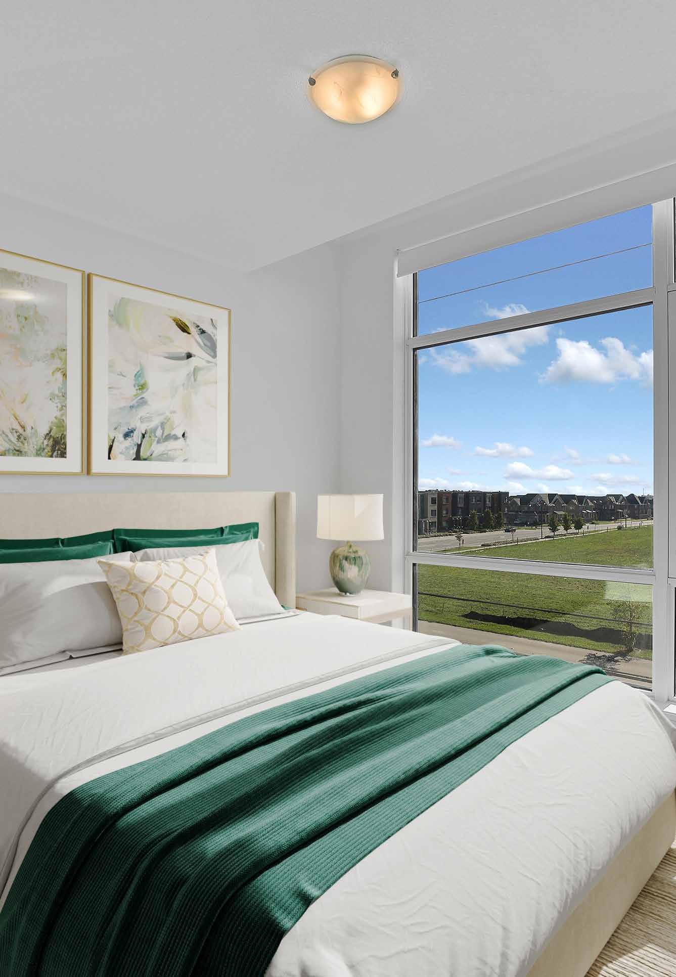 Primary bedroom with large window and green accents